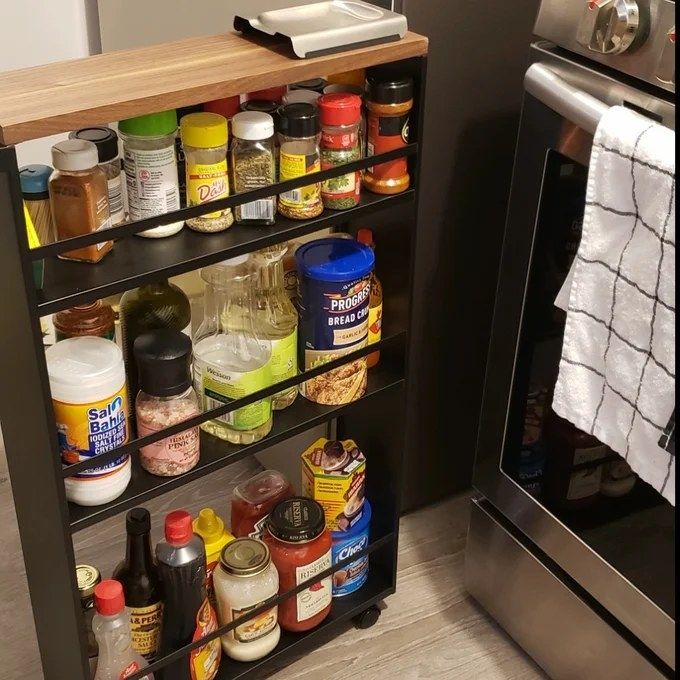 An image from a reviewer showing a rolling cart filled with condiments placed next to the stove.