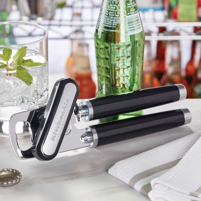 The can opener featuring a built-in bottle opener in a kitchen setting