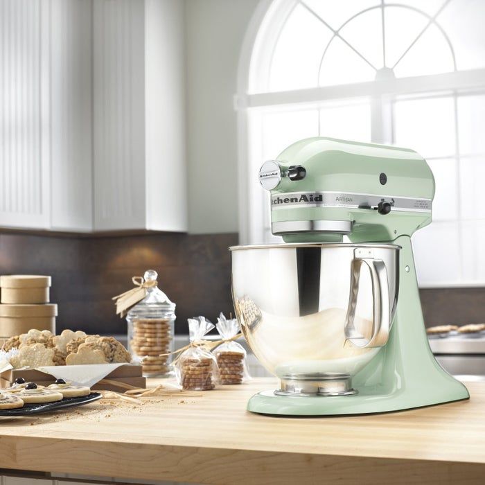The mixer sitting on the countertop beside a batch of cookies