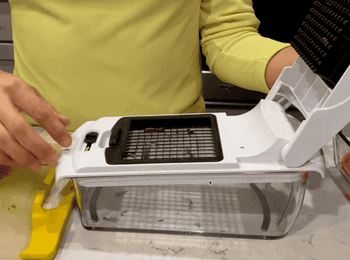 A reviewer chopping an onion with the veggie chopper