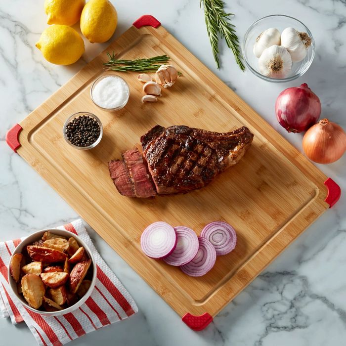 A steak placed on a wooden cutting board atop a kitchen counter