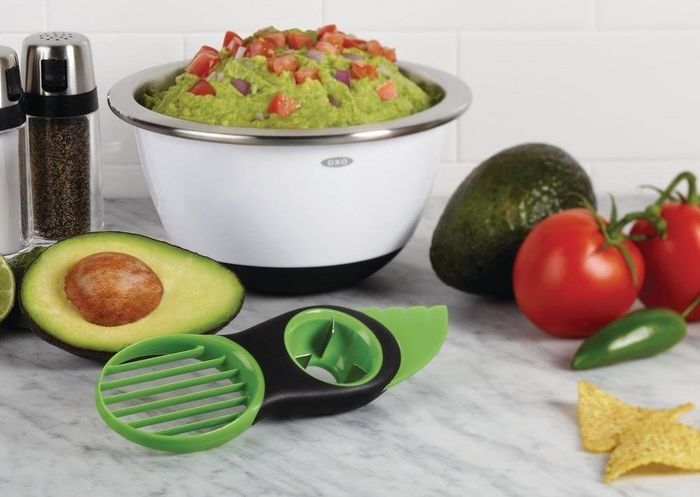 The tool placed in front of a bowl of freshly made guacamole.