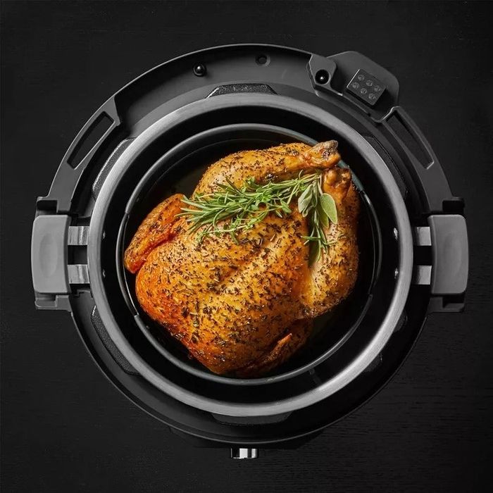 A whole roasted chicken seasoned with herbs, cooked effortlessly in an Instant Pot, ideal for quick and convenient home meals