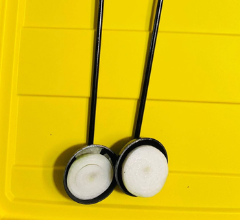 Two onion holders, each with half an onion placed on them.