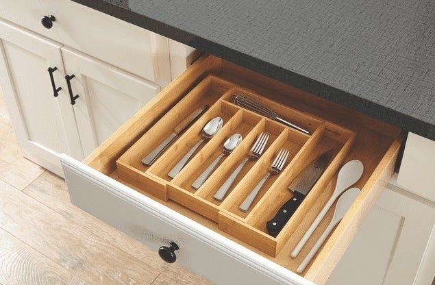 the organizer neatly arranged inside a kitchen drawer, holding various utensils