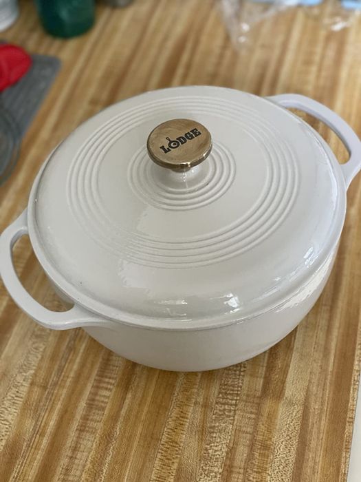 A reviewer shows off their white Dutch oven.