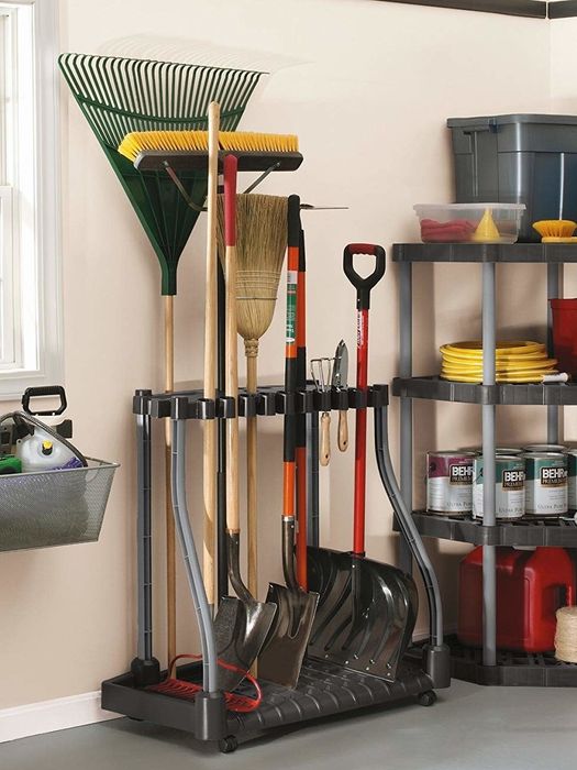 A lifestyle image of the stand holding various gardening tools, such as shovels, rakes, and more