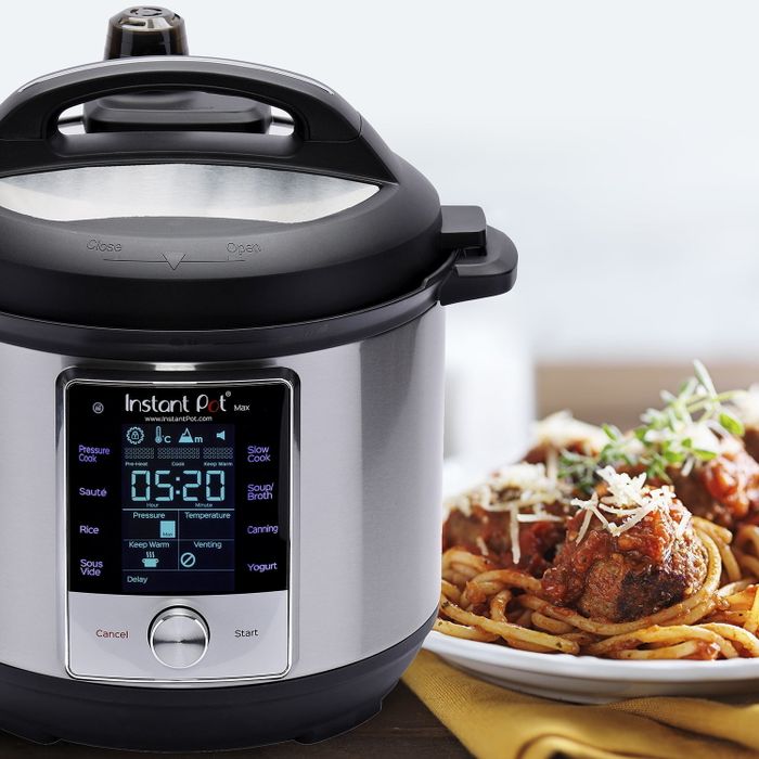 The Instant Pot beside a plate of spaghetti