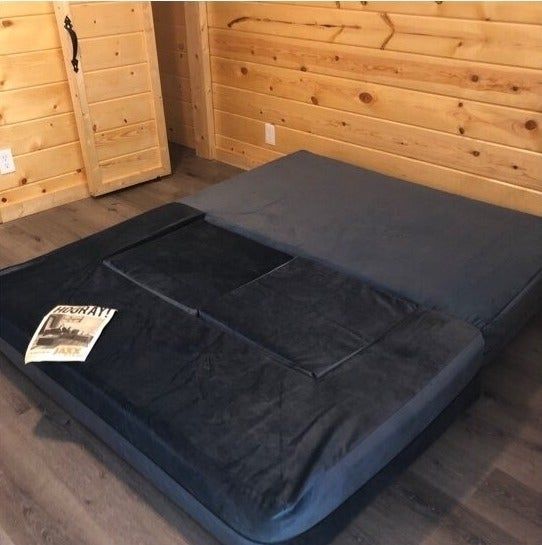 a customer photo of the navy blue sofa unfolded into a queen-sized bed
