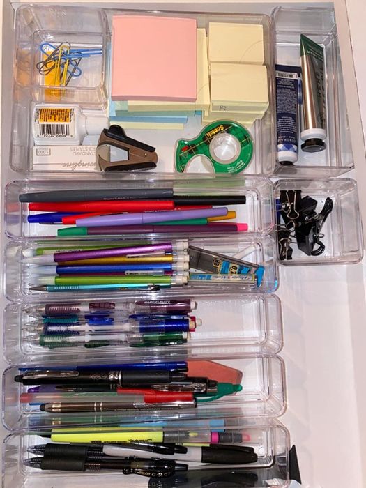 A reviewer’s photo showing the drawer organizers being used to store office supplies