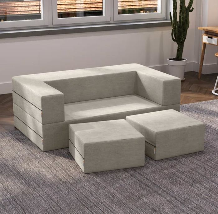 a rectangular-style sofa paired with two matching footrests