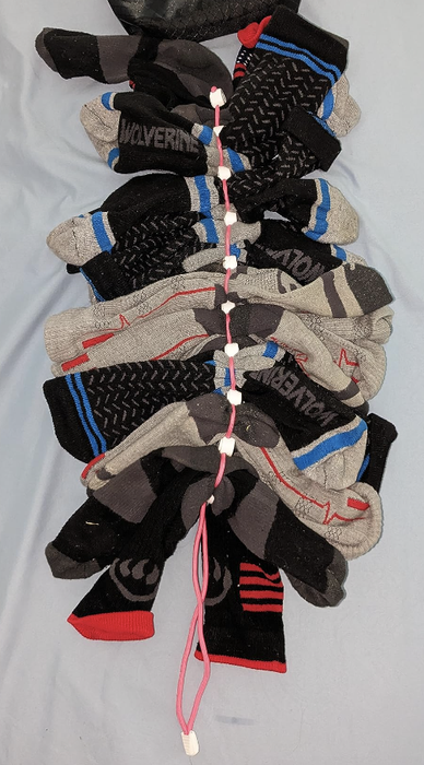 Assorted socks hanging on a line with text design accents, perfect for shopping for different styles