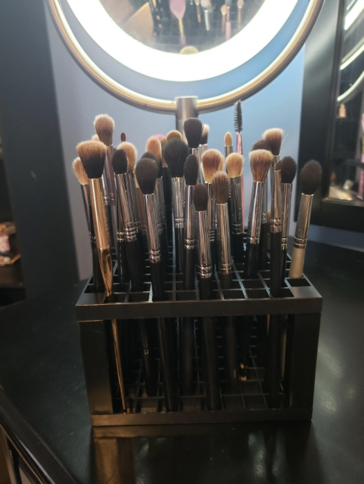 Several makeup brushes placed neatly in the container