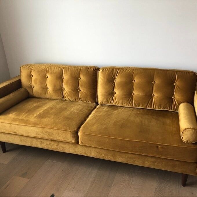 a customer photo of the golden velvet sofa