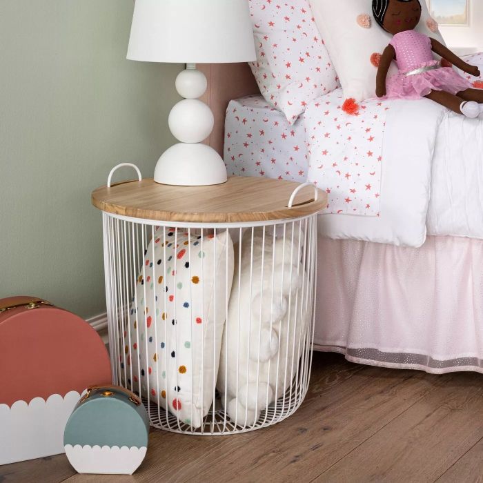 The storage bin, filled with various items, and with additional items placed on top