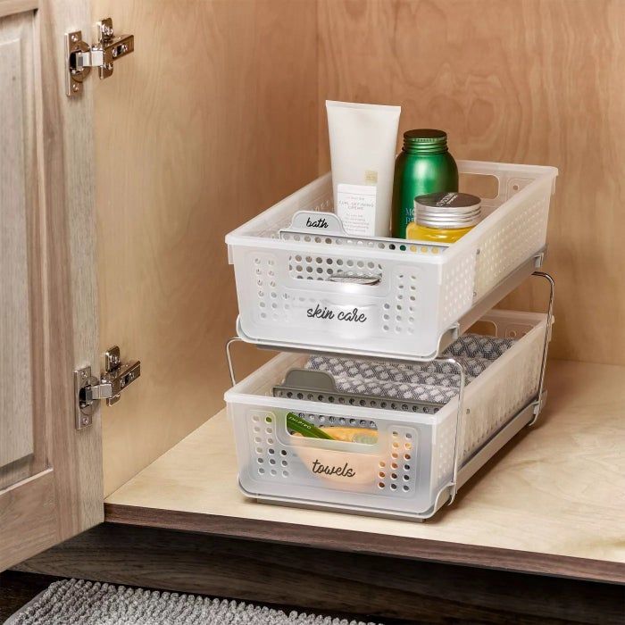 The two-tier organizer neatly arranged in a cabinet, holding various items inside