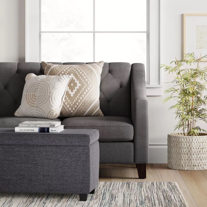 The storage ottoman placed in a living room setting
