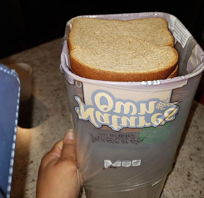 Reviewer's photo of the bread dispenser box open, showing a fresh slice of bread