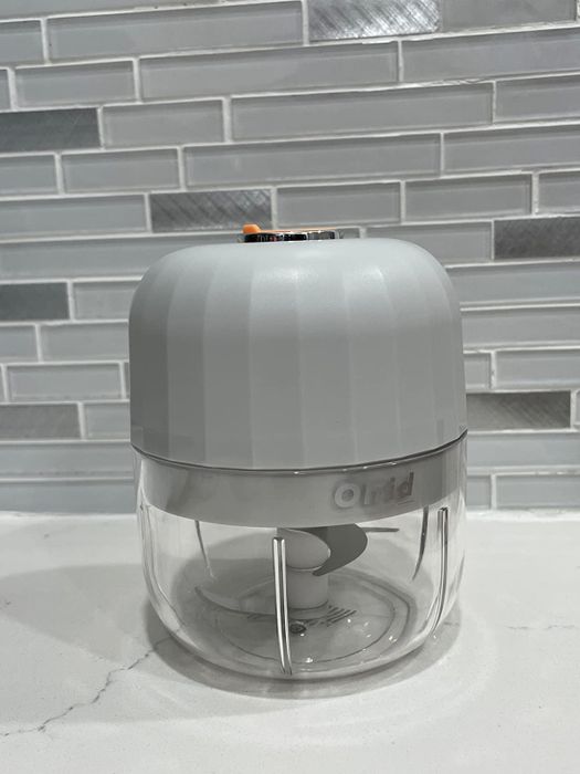 A reviewer demonstrating the wireless garlic chopper.