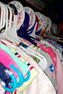Reviewer's closet filled with clothes organized using floral-patterned dividers