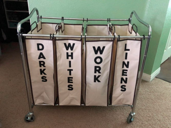 Review image of the cart neatly divided into four sections: 'darks, whites, work, and linens'
