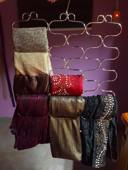 Scarves neatly hung on a hanger with a unique design that allows them to be tucked into the loops