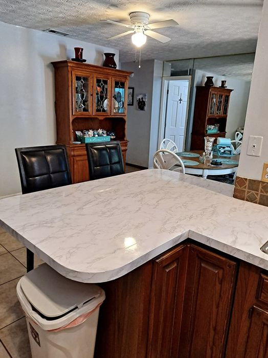 The same reviewer displays their countertop, now fully covered in marble contact paper.