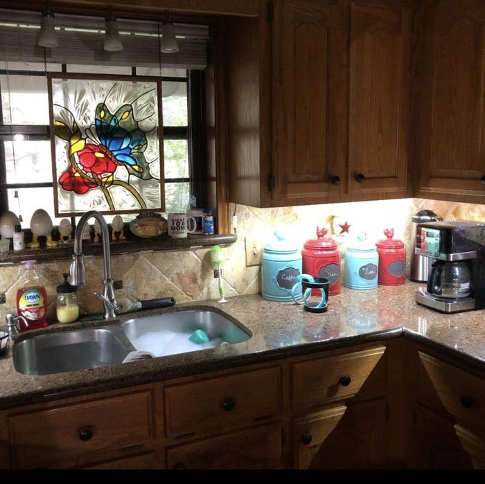 Same reviewer’s kitchen after installing the under-cabinet lights, now significantly brighter and more illuminated.