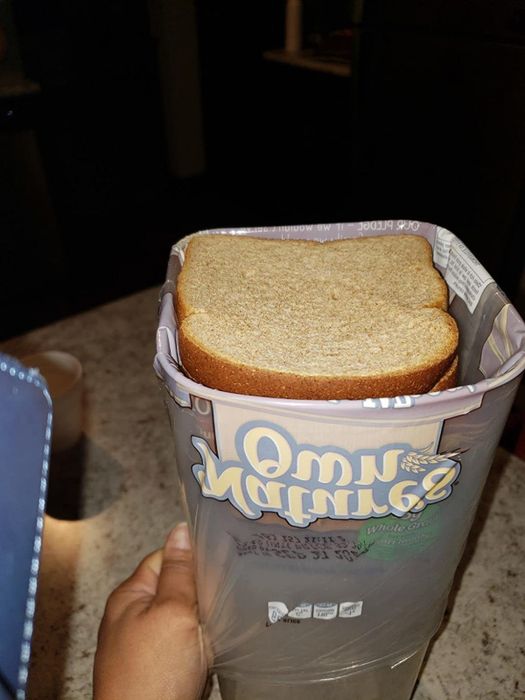 A review photo showing the bread dispenser box open with a fresh slice of bread inside.