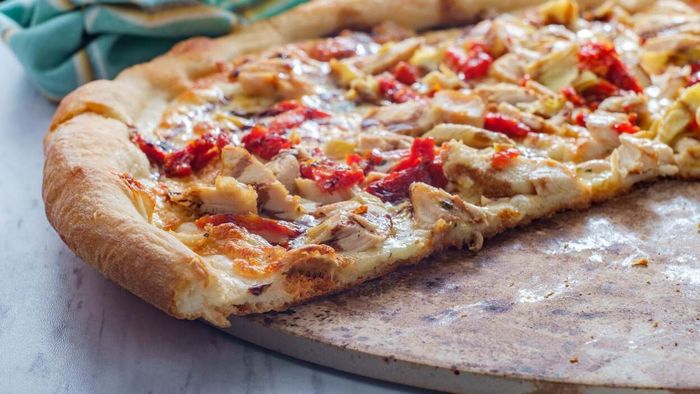 Skip the sheet pan and go for a pizza stone or baking steel