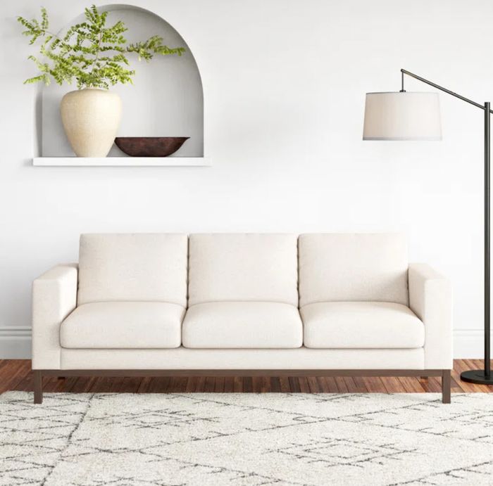 a sleek white three-seater sofa