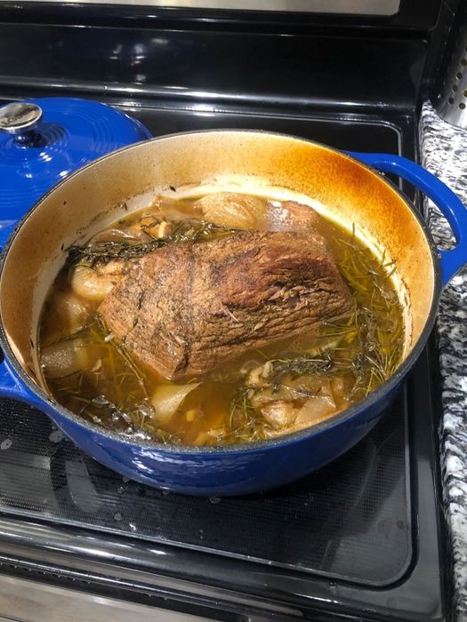 A reviewer shares a photo of a roast cooking inside their blue Dutch oven.