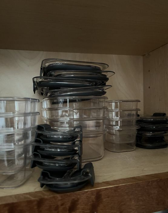 Storage containers neatly organized in a cupboard
