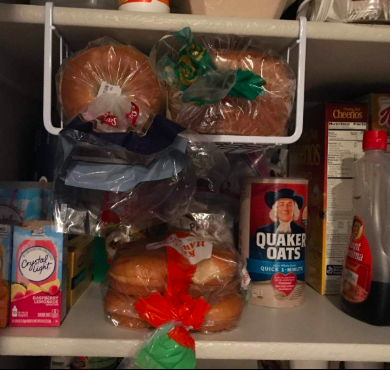 A photo of slide-on baskets mounted under a shelf, efficiently holding loaves of bread in previously unused space