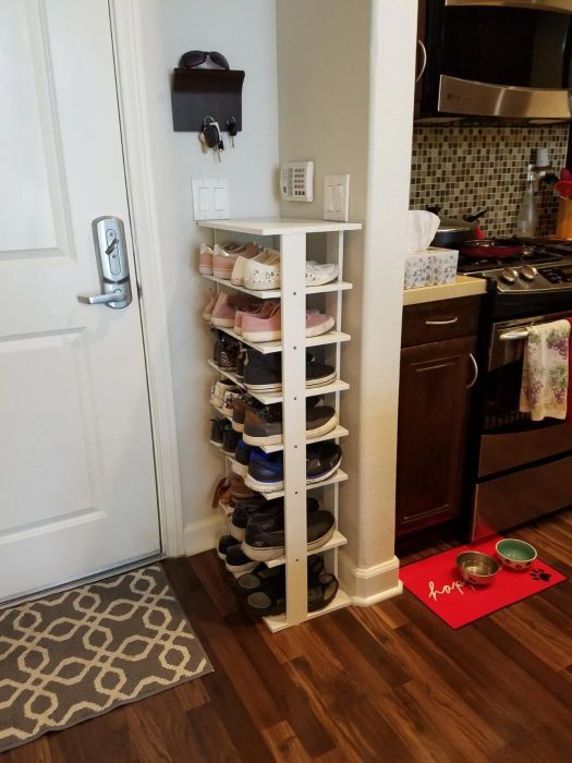 Reviewer displaying a side view of the shoe tower, showing how slim it is and fits neatly next to a door.