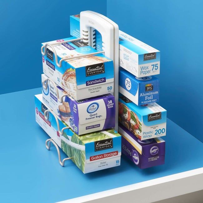 A vertical organizer with adjustable clips on the side, designed to store various boxes securely.