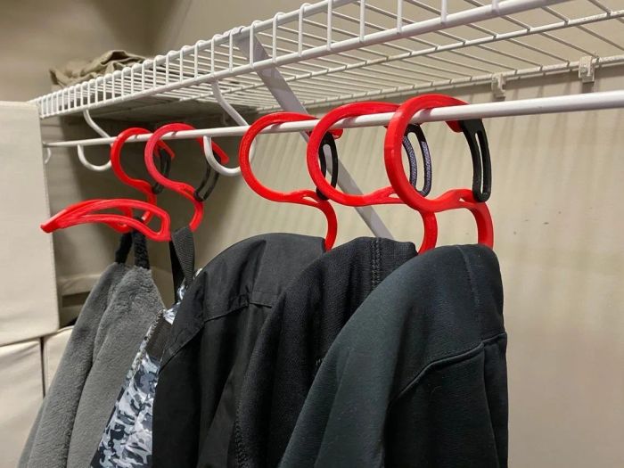Five hoodie hangers, each holding a cozy hoodie, hanging in a closet