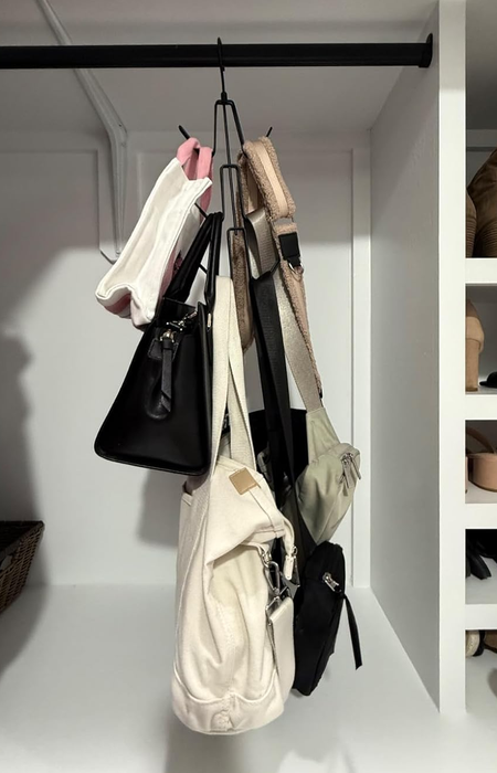 a hanging organizer with purses neatly suspended from each hook