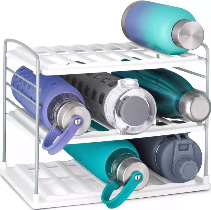A kitchen organizer that keeps multiple reusable water bottles neatly stored on its shelves, offering a practical solution for space-saving.