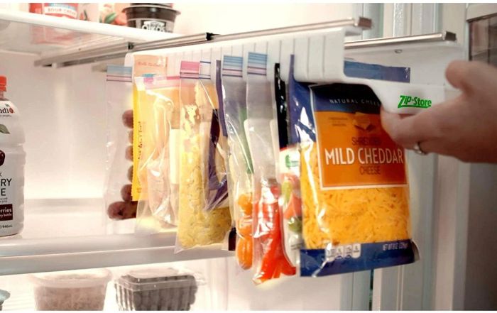 The sliding organizer filled with bags of cheese