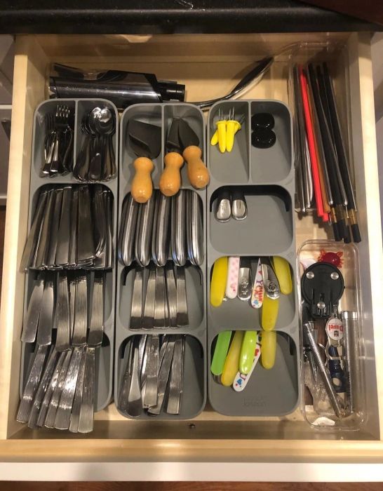 Reviewer photo showcasing an open drawer containing three separate organizers placed side by side, each filled with an assortment of different utensils.