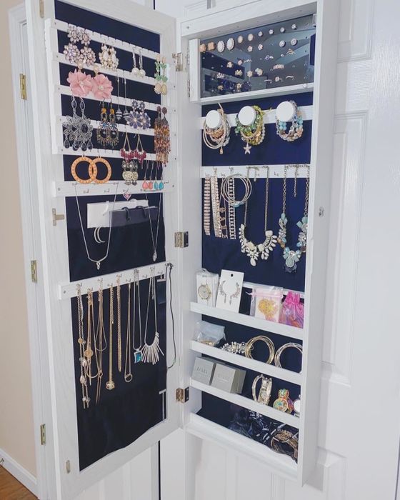 A reviewer's photo of the cabinet open, showcasing its organized jewelry storage