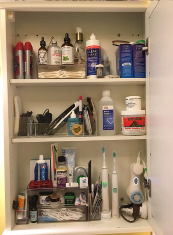 The same reviewer showcasing their now neatly organized cabinet, highlighting the increased storage capacity