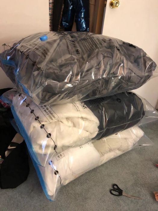 A reviewer's comforters and pillows neatly packed into pre-flattened jumbo space saver bags.
