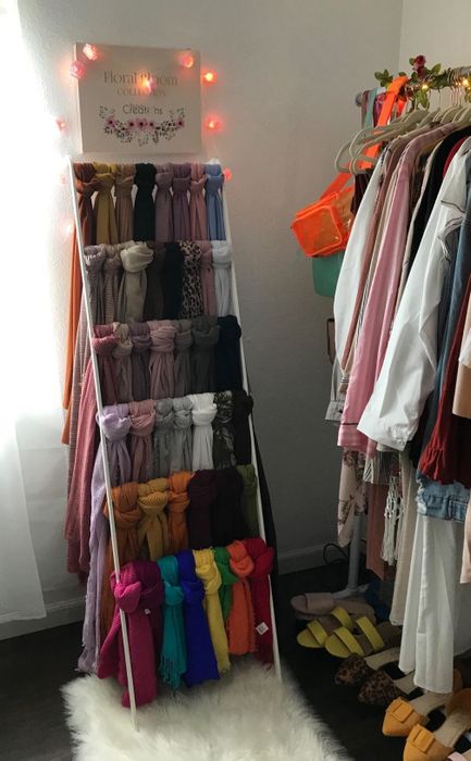 scarves neatly draped over the leaning ladder