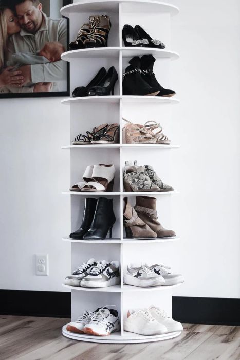 A mix of men's and women's shoes neatly arranged on a white shelving unit, showcasing a well-organized closet display