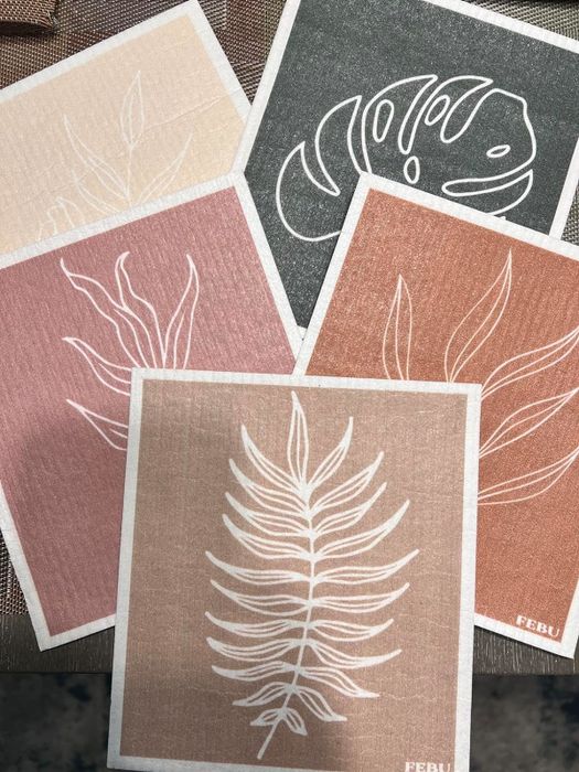 Swedish dishcloths featuring leaf patterns, neatly arranged on a countertop