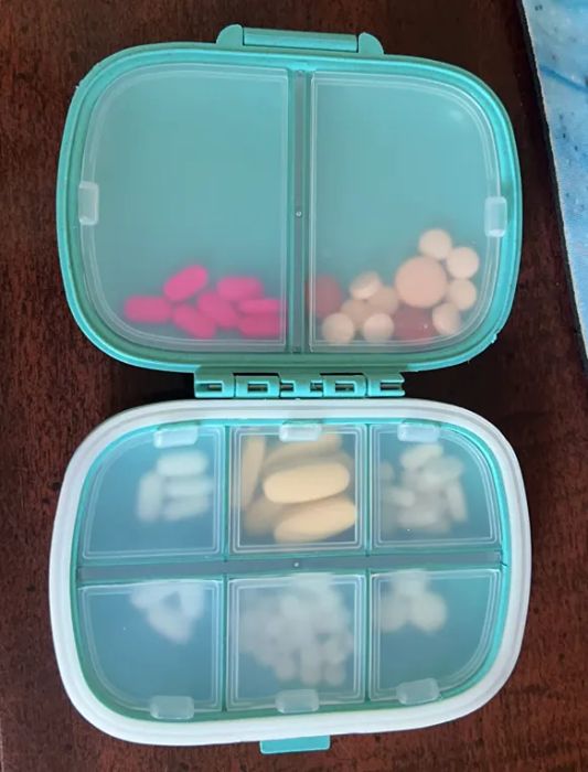 A photo from a reviewer showing a pill organizer that opens like a book