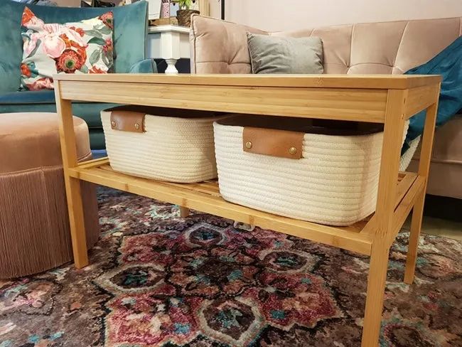 A reviewer’s image showing two white woven baskets with brown handles, neatly arranged on a shelf of a coffee table.