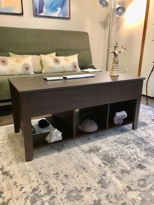 A photo from the reviewer showing the brown coffee table with three storage cubbies located at the bottom.